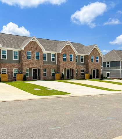 a large brick apartment building with a driveway