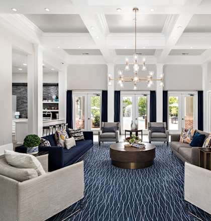 a living room with couches and chairs and a table