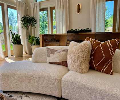 a living room with a couch and pillows on it