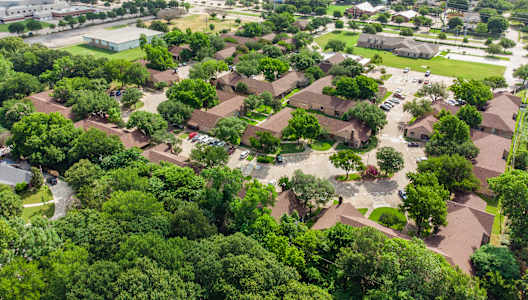 A bird's eye view of a residential area with houses and trees.