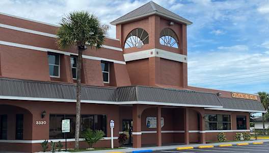 a building with a clock tower on top of it at Colonial Drive Apartments, Orlando, 32808