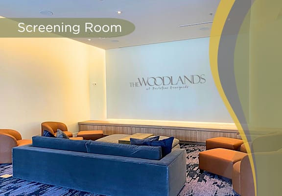 a screening room with a blue couch and chairs