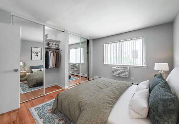 a bedroom with a large bed and a large mirror