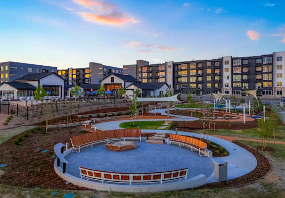 a view of a park with a playground and buildings