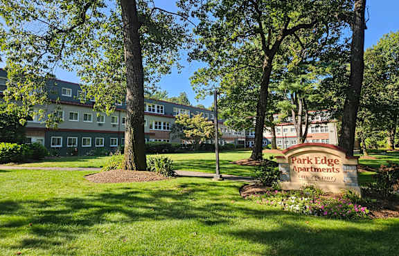 A sign for Park Edge Apartments is in front of a grassy area at Park Edge, Massachusetts, 13502