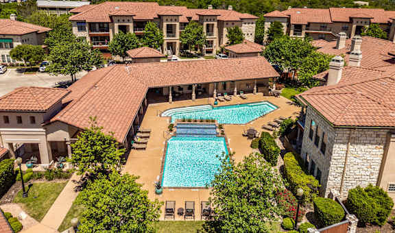 an aerial view of the pool at the resort on a sunny day