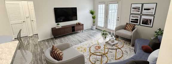 A living room with a grey sofa, a white armchair, a wooden coffee table, and a television on a wooden cabinet.