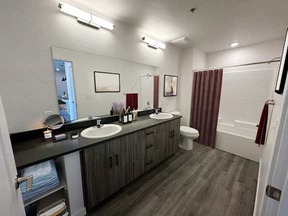 a bathroom with two sinks and a shower and a toilet at Crosshatch, Garden City, ID, 83714