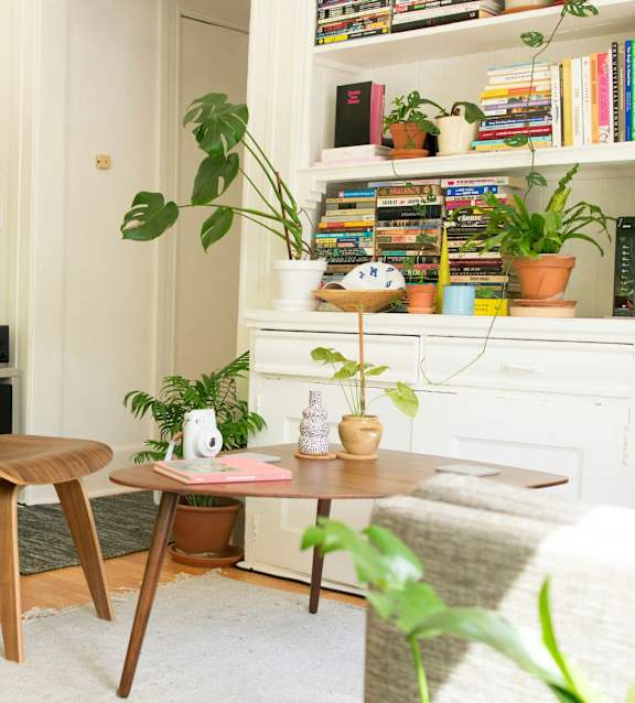 a bedroom with a bed and a kitchen and a living room
