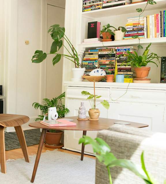 a bedroom with a bed and a kitchen and a living room