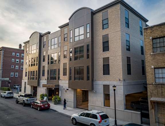 a new apartment building on a city street with cars  at Nineteen North, Buffalo, 14202