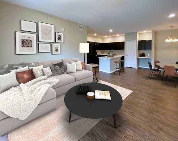 A modern living room with a grey couch and a coffee table in the center.