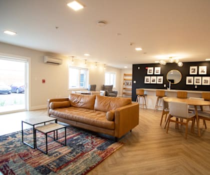 A living room with a tan couch and a coffee table.