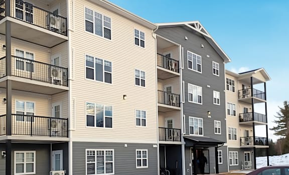Apartment buildings with balconies and doors are shown in the image.