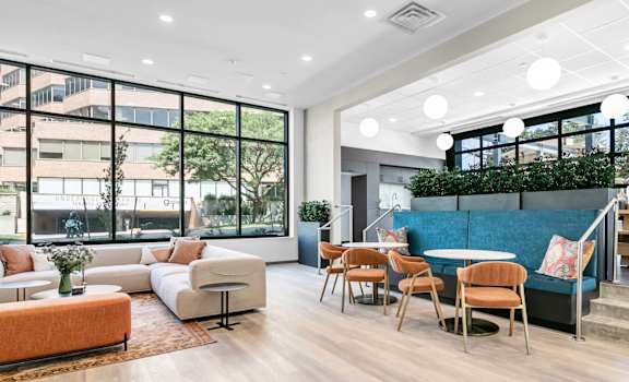A modern living room with a large window and a view of the city.