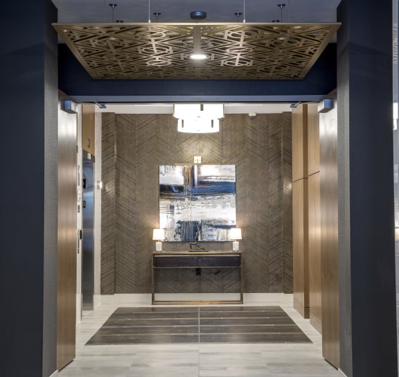 a view of the elevator lobby of a building with a blue and gold elevator lobby  at Nineteen North, NY 14202