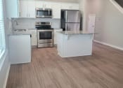 Thumbnail 60 of 60 - B4 Kitchen with laminate wood flooring, granite countertops, and stainless steel appliances