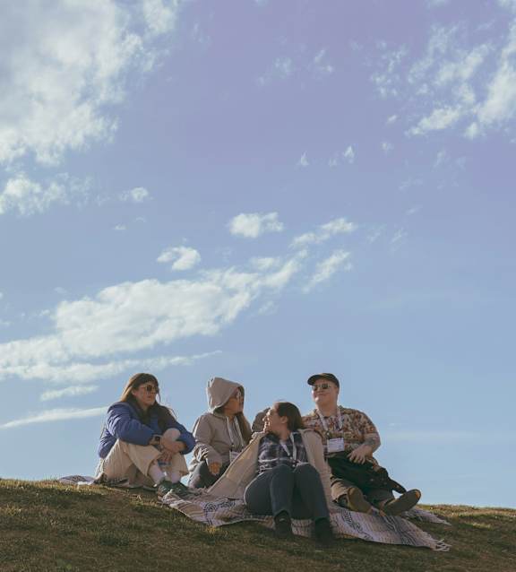 A man and woman are having a picnic in a field.