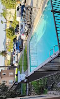 an overhead view of a pool with blue water and black stairs