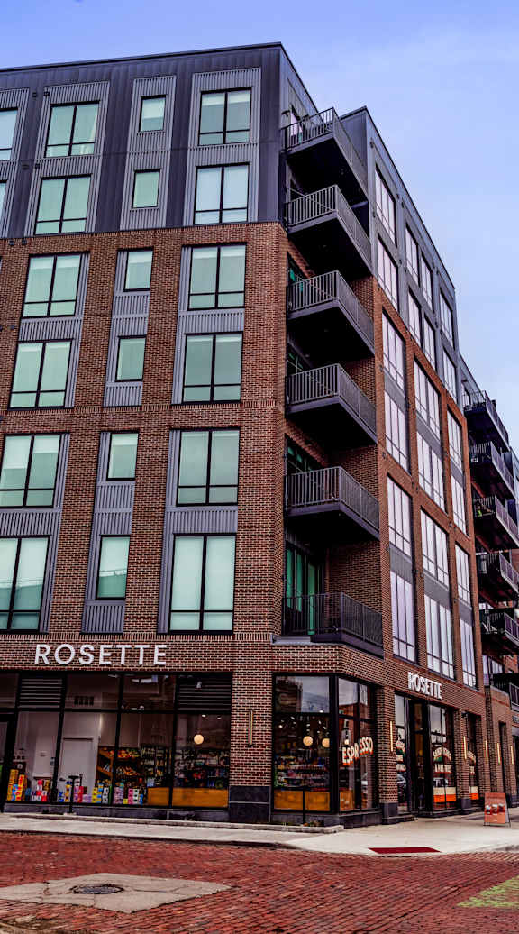 A brick building with a sign that says "Rosette" on it.
