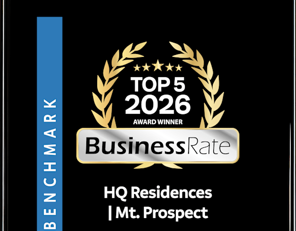 A black and gold award sign for HQ Residences Mt. Prospect.