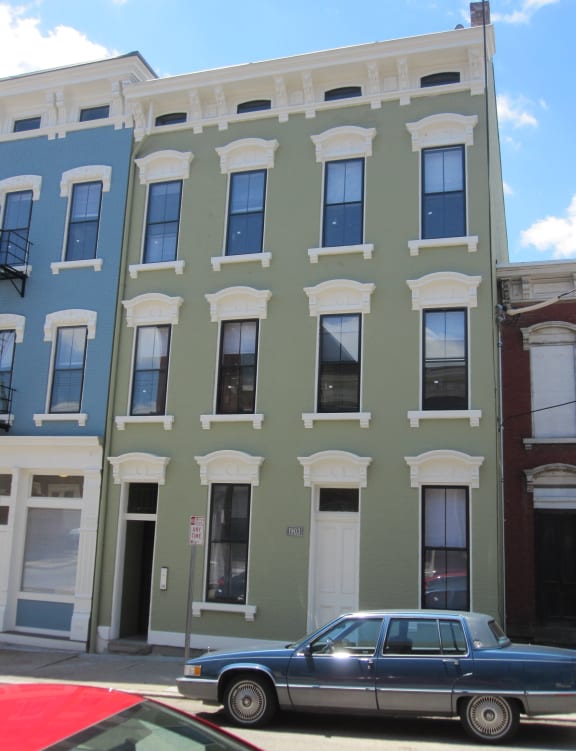 a car parked in front of a building on a city street