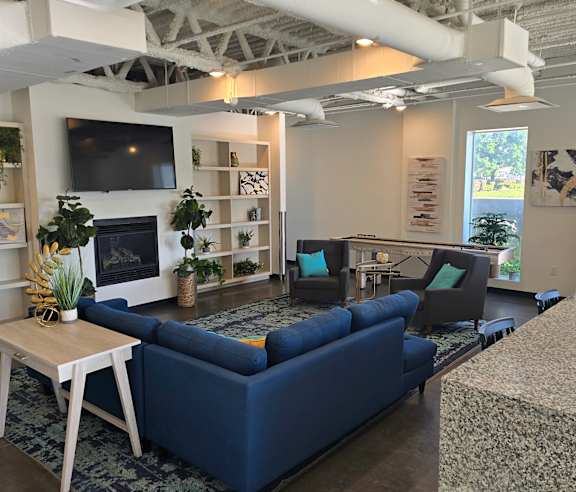 A white and blue couch in a room with a white wall.