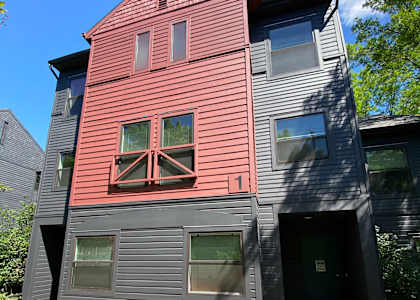 the front of a house with a red and black facade