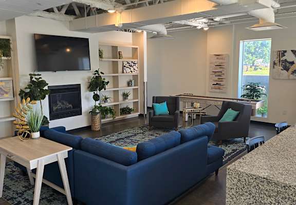 A white and blue couch in a room with a white wall.