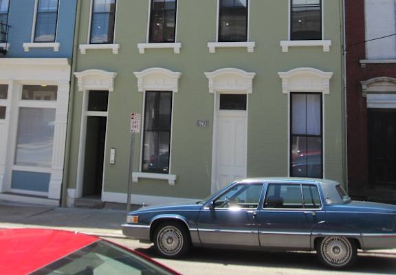 a car parked in front of a building on a city street