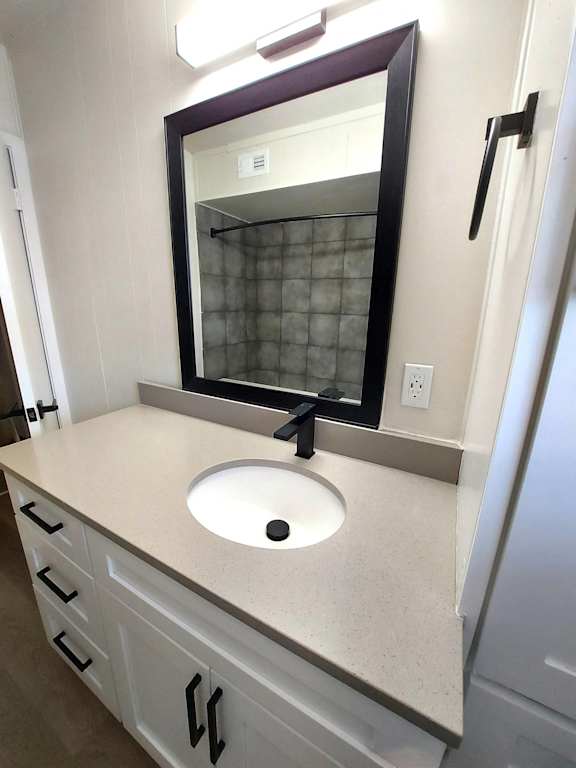 a small bathroom with a sink and a mirror