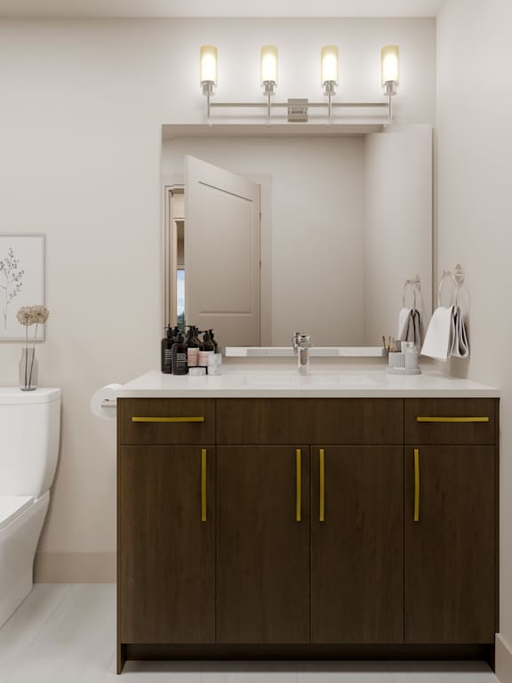 A bathroom with a brown cabinet and a white tub.