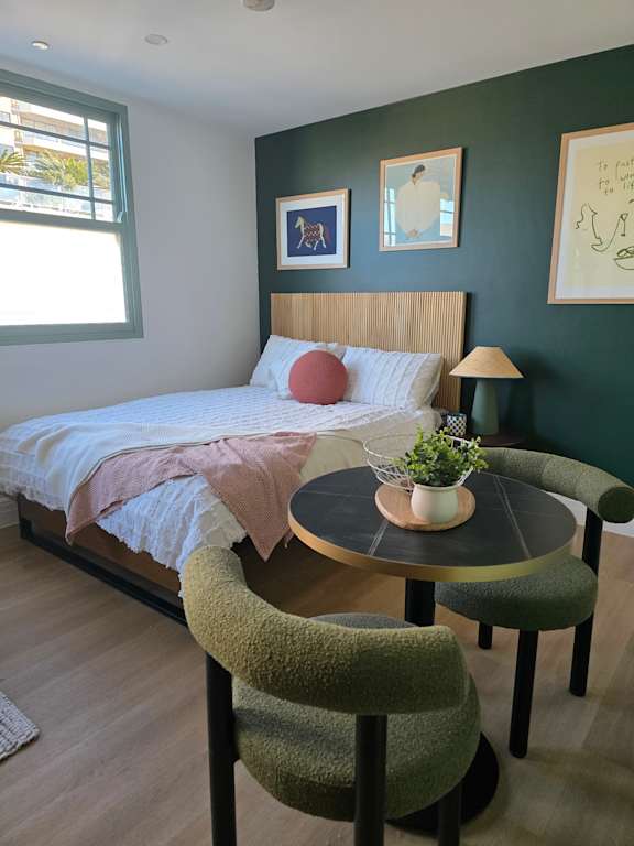 A round table with a plant on it is in the middle of a room.