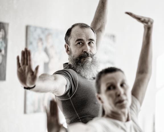 a man and a woman are in a yoga class