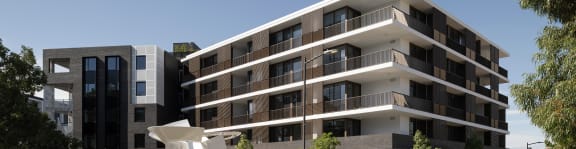 a picture of a building with balconies and a sculpture in front of it