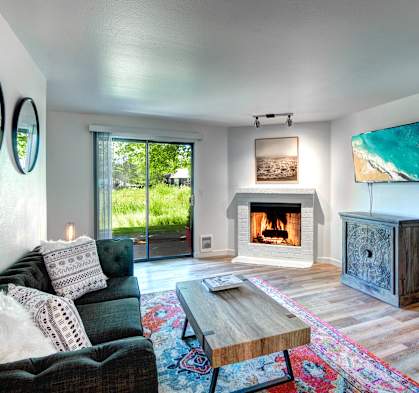A modern living room with a fireplace and a flat screen TV.