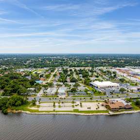 an aerial view of a city with a body of water