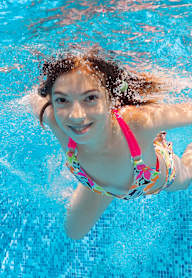 A girl swimming in a pool.