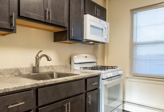 kitchen with brown cabinets at Loch Bend Apartments, Baltimore