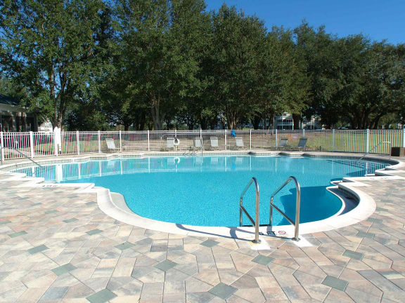 a swimming pool with a fence around it at Audubon Oaks, Lakeland, FL 33809