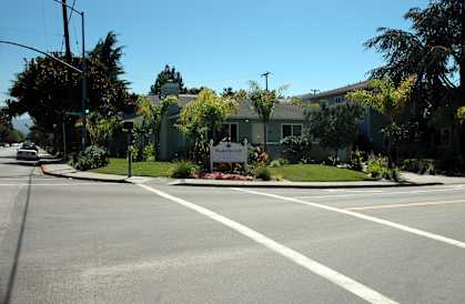 an empty street in front of an apartment building