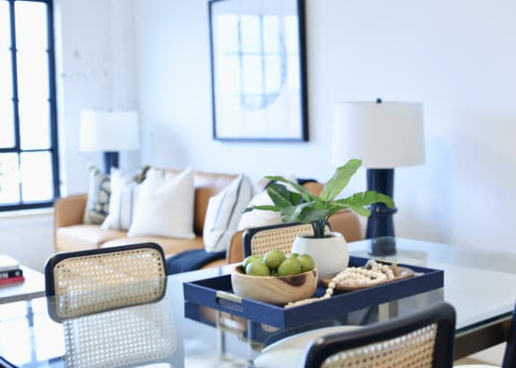 a living room with a table with a bowl of fruit on it