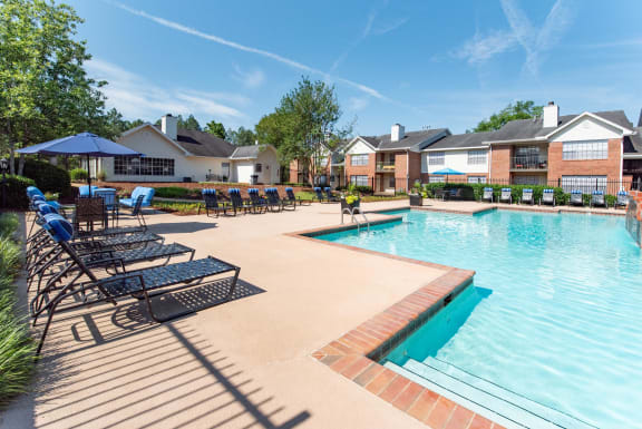 our apartments offer a swimming pool with lounge chairs and umbrellas