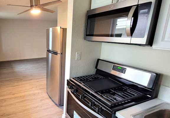 a kitchen with a stove and a refrigerator