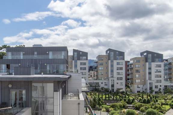 a group of buildings with a cloudy sky in the background