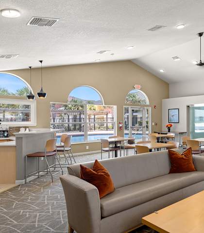 a living room with couches and chairs and a table with chairs