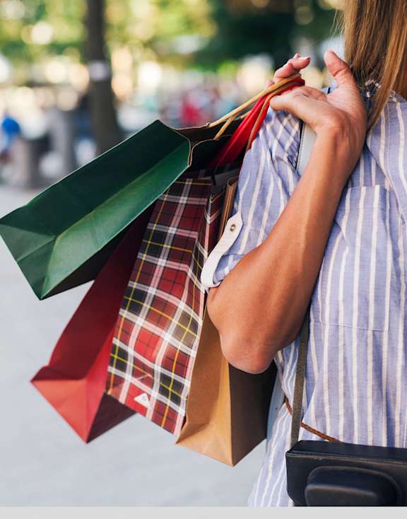 a woman holding a bunch of shopping bags and ties at Carmel Vista, McDonough, Georgia