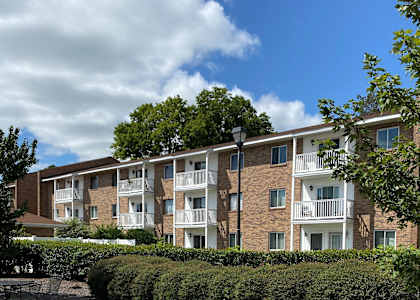 an apartment building with brick exterior and balconies