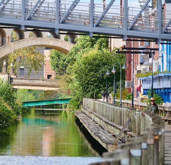 A bridge over a river with a greenish hue.