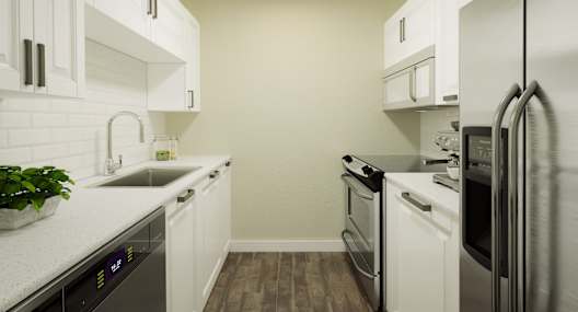 A kitchen with white cabinets and stainless steel appliances.